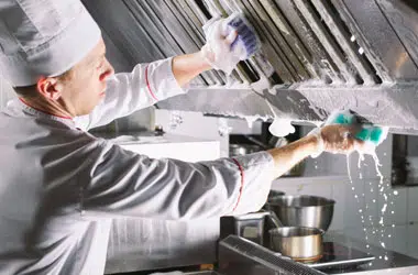 A man performs deep cleaning of kitchens at Hygen Cleaning Company