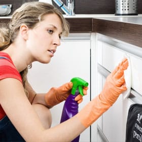 A woman cleans laundry, kitchens and bathrooms