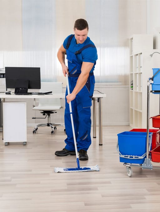 A man cleaning office floors and walls